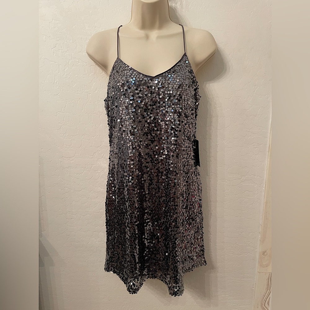 Silver night out dress with shimmering beads. New with tags from express.